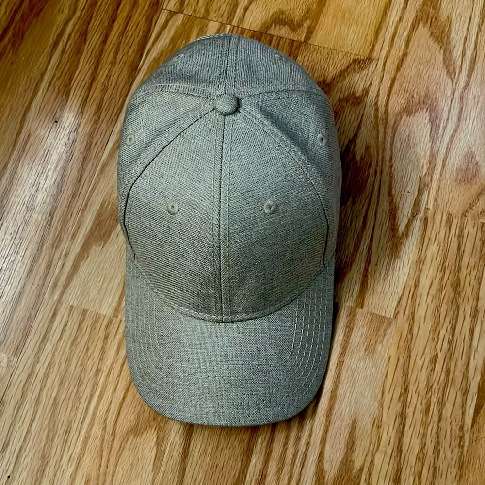 Beige colored hat. Never been worn, smooth fit with a Velcro backing.